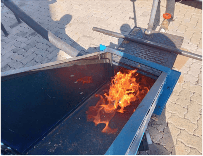 A Ferocious corncob generated fireball at the furnace entrance is observed through the channel.
